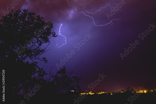 Rays in a night storm with light and clouds.