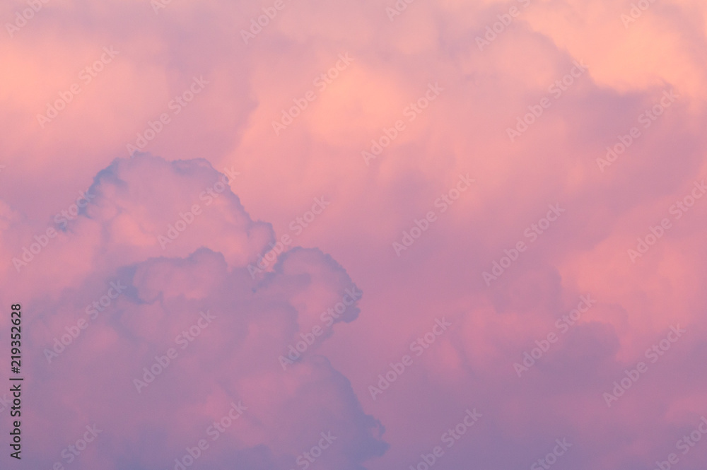 Magnificent colorful clouds in the evening sky. Bright, pink clouds in the sky at sunset. Beautiful evening skyscape. Abstract, purple pink background. Vibrant color photograph. Magnificent colorful clouds in the evening sky. Bright, pink clouds in the sky at sunset. Beautiful evening skyscape. Abstract, purple pink background. Vibrant color photograph.
