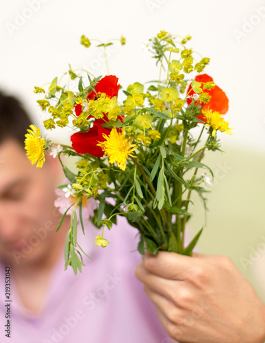 Wallpaper Mural bright wild flowers in a person's hand Torontodigital.ca