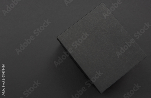 Black and white gift box on a dark contrasted background, creating a romantic atmosphere. Typically used for birthday, anniversary presents, gift cards, post cards.