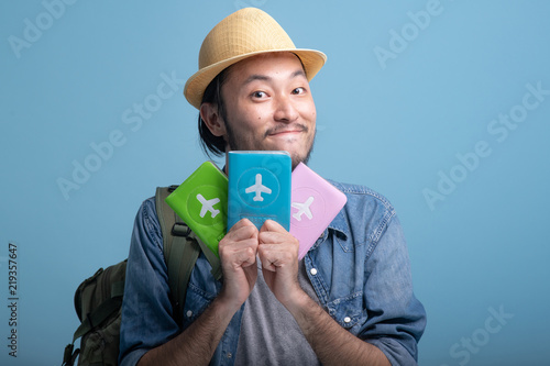 Young bearded man backpacking traveller in blue background.