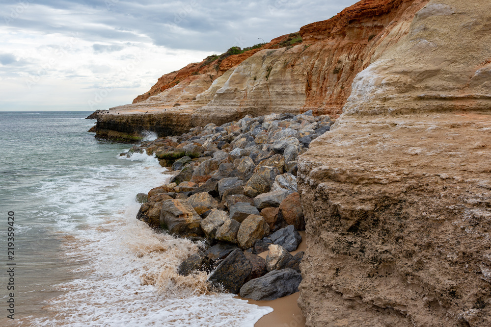 The eroding cliffs at Port Noarlunga and the protective rocks placed as a prevention method in South Australia on 23rd August 2018