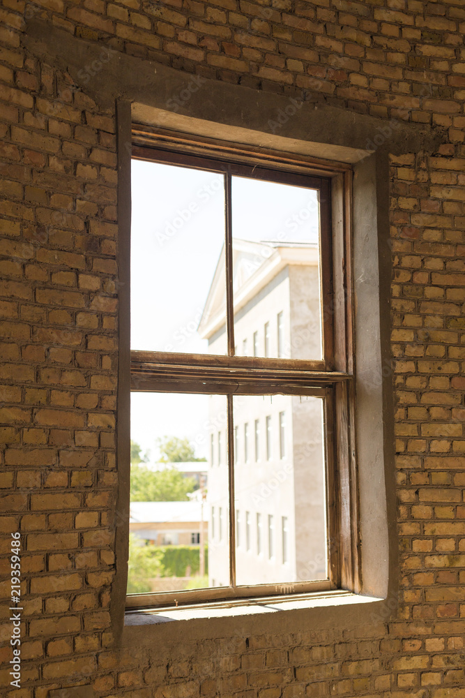 Fototapeta premium Old brick windows from inside the building and sunlight