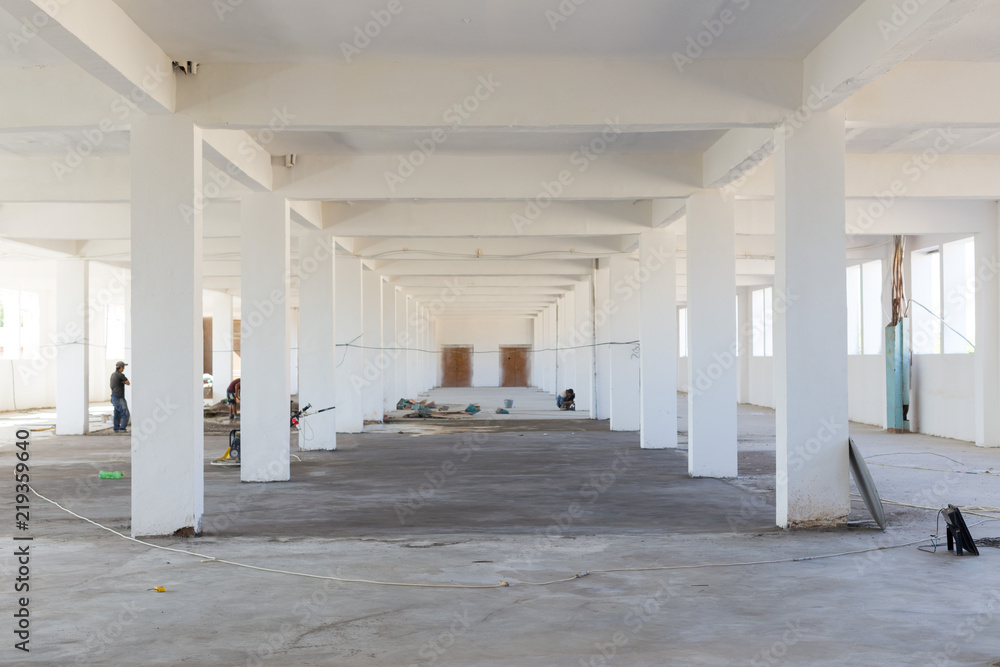Unfinished interior of business center under construction in grey colours