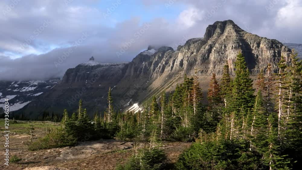 late afteroon light on mt pollock and bishops cap on a stormy day at glacier national park in montana, usa late afteroon light on mt pollock and bishops cap on a stormy day at glacier national park in montana, usa
