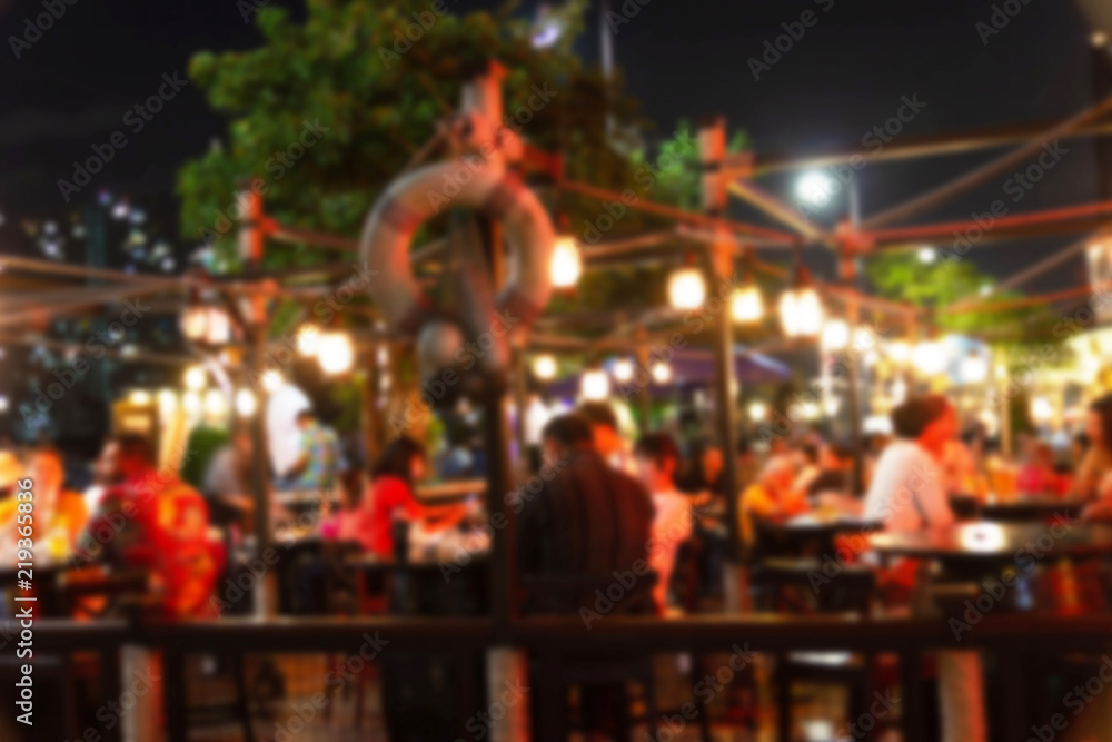 abstract blur image of night festival in a restaurant and The atmosphere is happy and relaxing with bokeh for background, Bangkok Thailand.