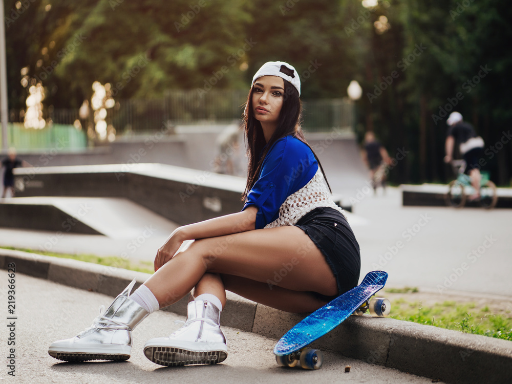 beautiful sexy girl with long legs wis a skateboard - obrazy, fototapety, plakaty 