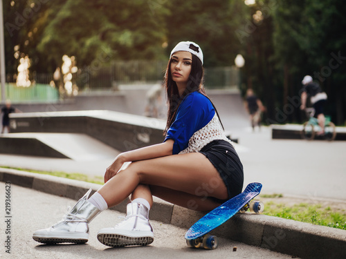beautiful sexy girl with long legs wis a skateboard