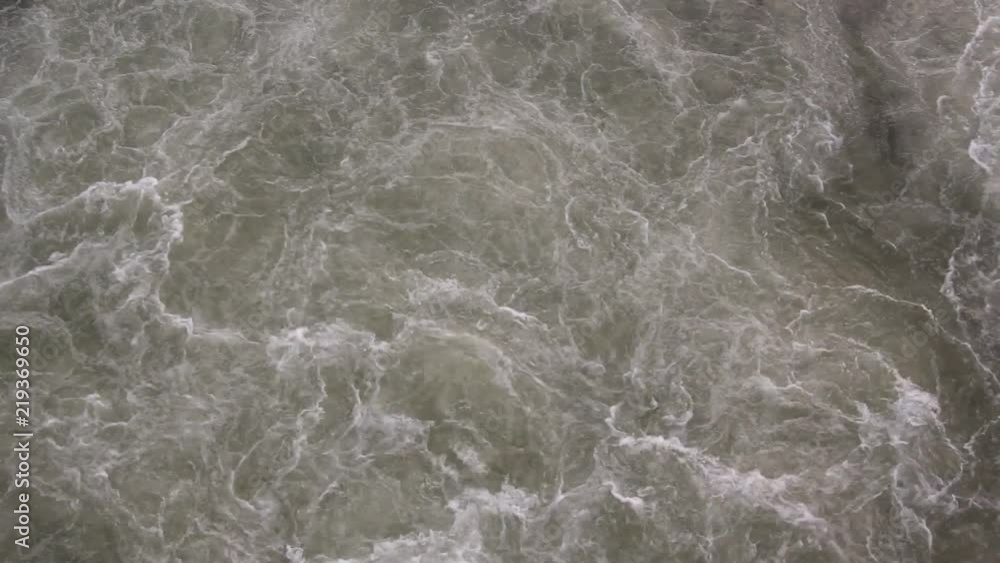 Aerial view of heavy underwater currents with full of small bubbles disturbing water surface, creating beautiful patterns. Aerial view of heavy underwater currents with full of small bubbles disturbing water surface, creating beautiful patterns.