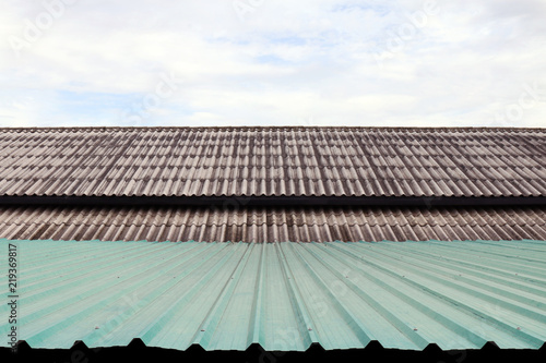 roof wavy tile and zinc, roofing tile old and zinc roof green, white or grey roofing tile old on sky background