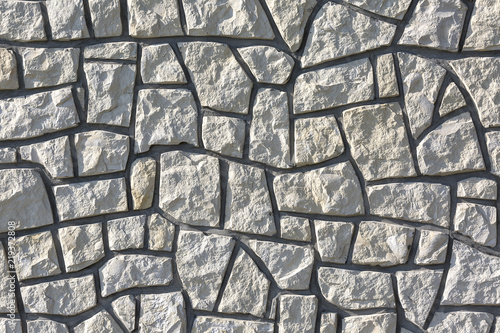 Decotative stone wall from pieces of stone, background