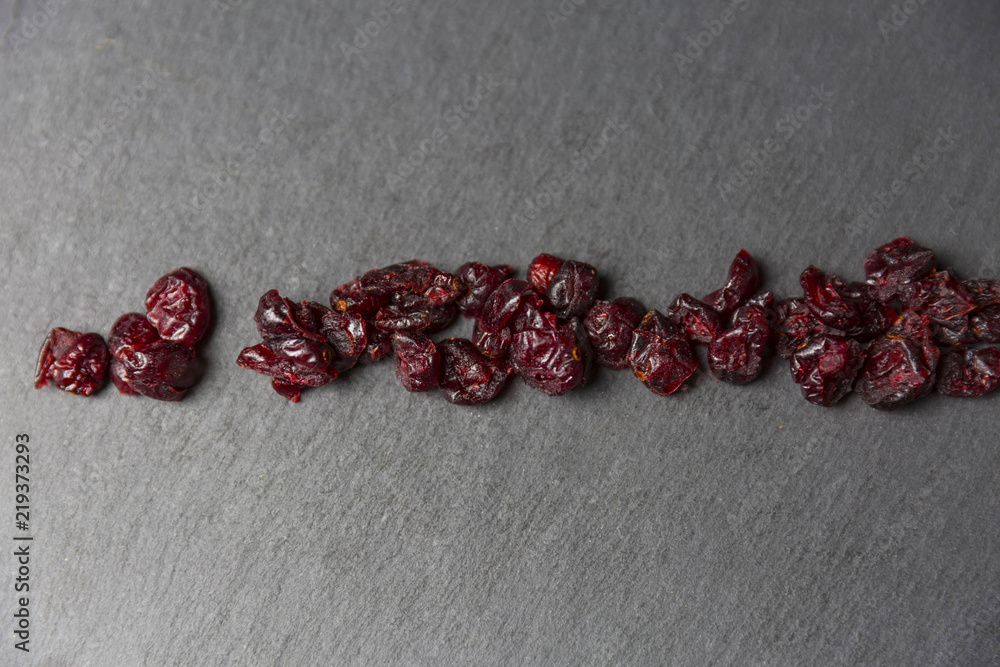 Dried Cranberries On Dark Stone Slab Dried Cranberries On Dark Stone Slab