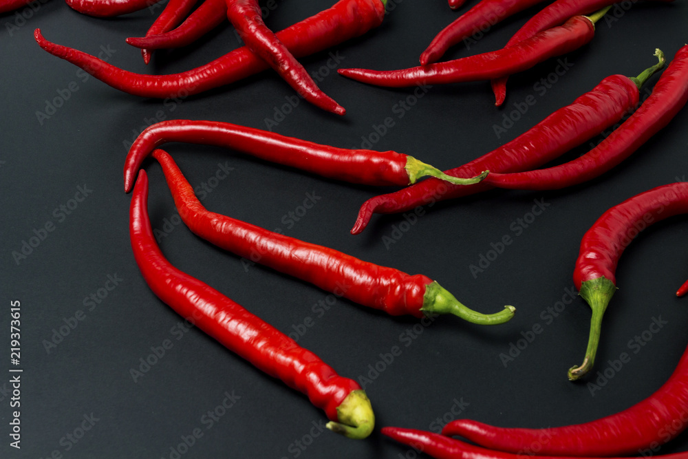 Red hot chili peppers on a black background Red hot chili peppers on a black background