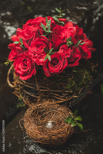 Classic wedding bouquet with red roses on dark stone background