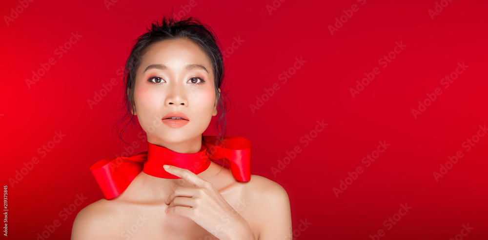 Asian tanned skin woman with strong color red lips Asian tanned skin woman with strong color red lips