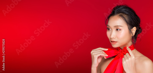 Asian tanned skin woman with strong color red lips © Jade