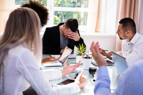 Bild auf Leinwand Businesspeople Blaming Their Colleague In Office