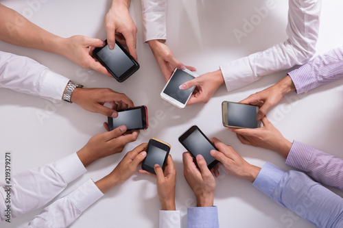 Group Of Businesspeople Using Smartphone