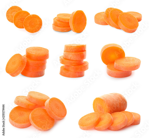 Set with ripe sliced carrots on white background