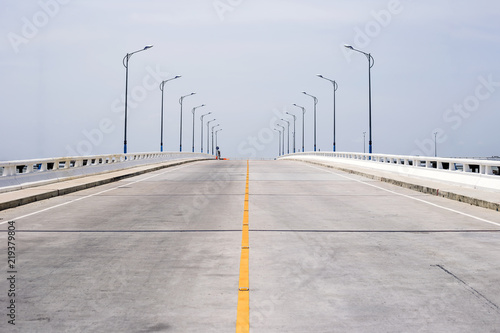 Slope of concrete road and clear sky background.