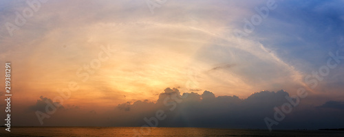 Panoramic sunset with fluffy clouds in the twilight sky Sunlight with dramatic cloud over sea