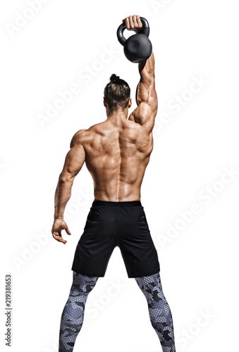 Fotografie Rear view of muscular man working out with kettlebell