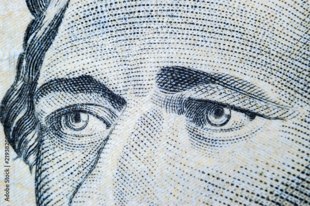 Close up view Portrait of Alexander Hamilton on the one ten dollar bill. Background of the money. 10 dollar bill with Alexander Hamilton eyes macro shot. Money background. Face portrait
