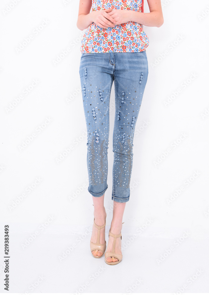 Front view women legs in pearlescent sequins jeans with high hell shoes Front view women legs in pearlescent sequins jeans with high hell shoes