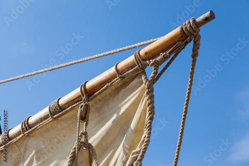 The sail on the mast of an old ship