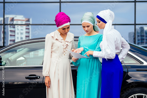 group of three successful business female students Muslims women in stylish veiled hijab a turban headscarf is tied up on the head