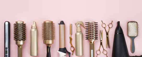 Professional hair dresser tools on pink background with copy space