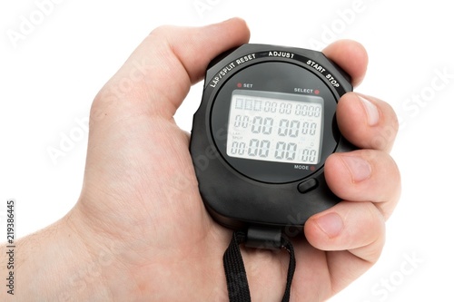 Close Up Of Hand Holding Digital Stopwatch on Blue Background