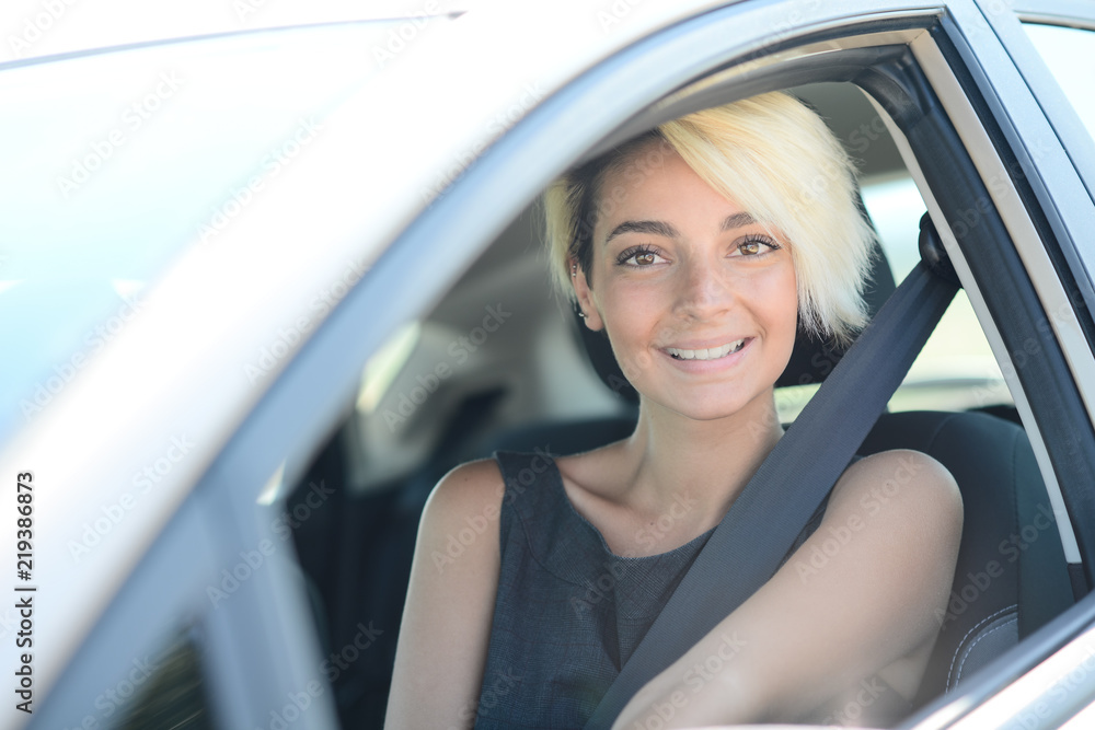 cheerful young blond business woman driving her brand new rental car cheerful young blond business woman driving her brand new rental car