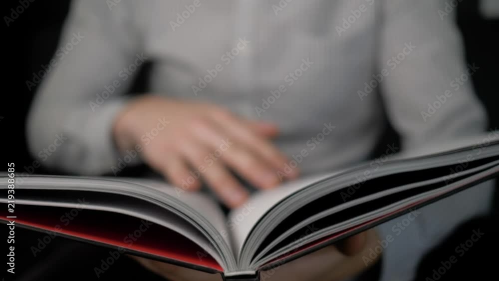 man's hands flipping through the book, lying on his knees. 4K man's hands flipping through the book, lying on his knees. 4K