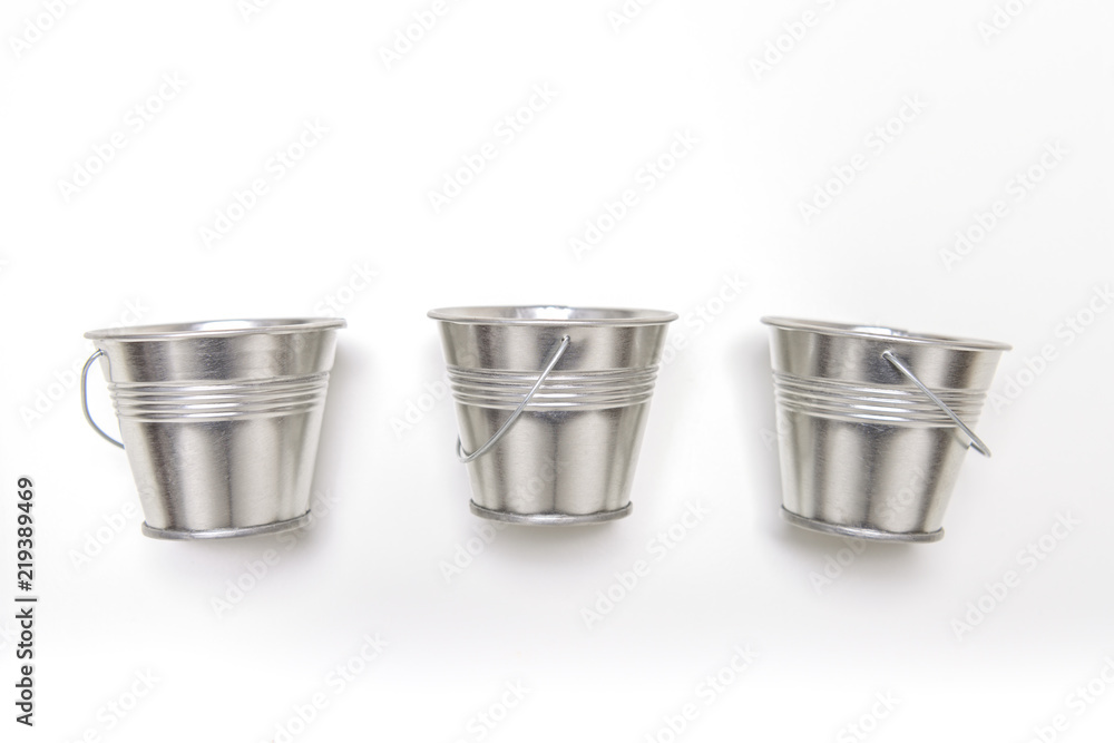 Three small empty metal bucket on white background. Three small empty metal bucket on white background.