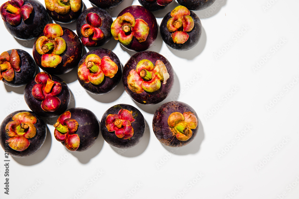 Group of Mangosteen fruits in top view on light grey background