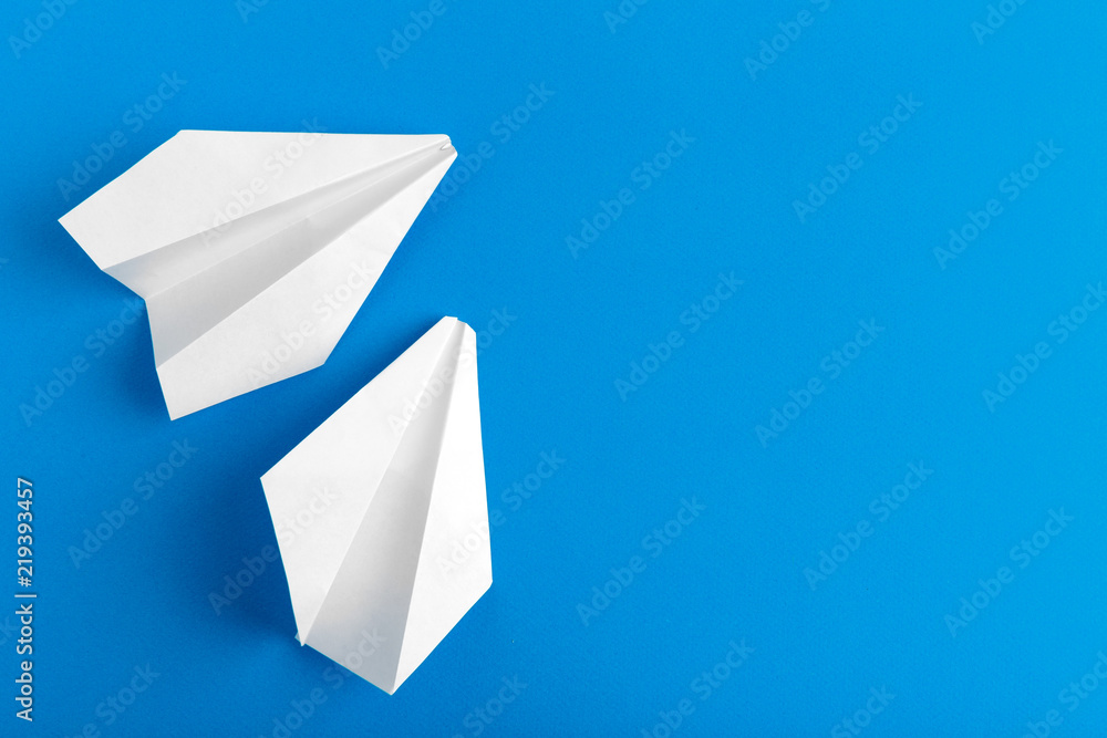 Flat lay of a paper plane on pastel blue color background Flat lay of a paper plane on pastel blue color background