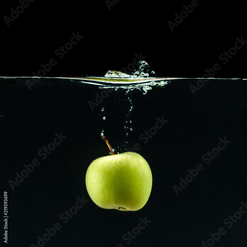 Green apple under water