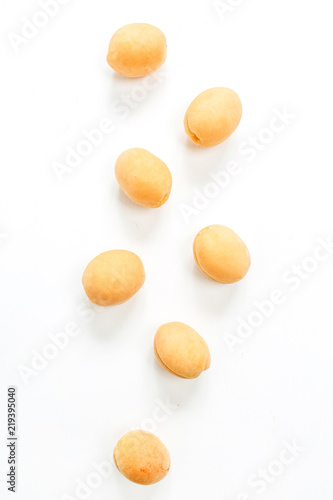 Yellow apricots on white background. Flat lay, top view.