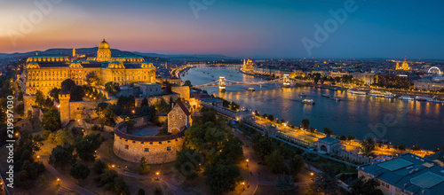 Budapest Hungary - Aerial panoramic skyline view of Budapest at blue hour with Buda Castle Royal Palace, Szechenyi Chain Bridge, Parliament, St.Stephen's Basilica and sightseeing boats on River Danube photo