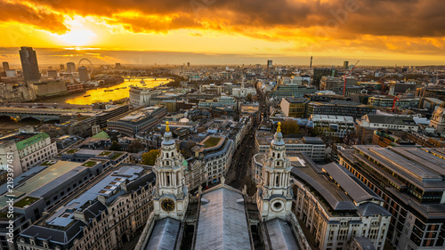 London, England - Aerial panoramic skyline view of London taken from top of St.Paul's Cathedral at sunset with beautiful golden sky and clouds