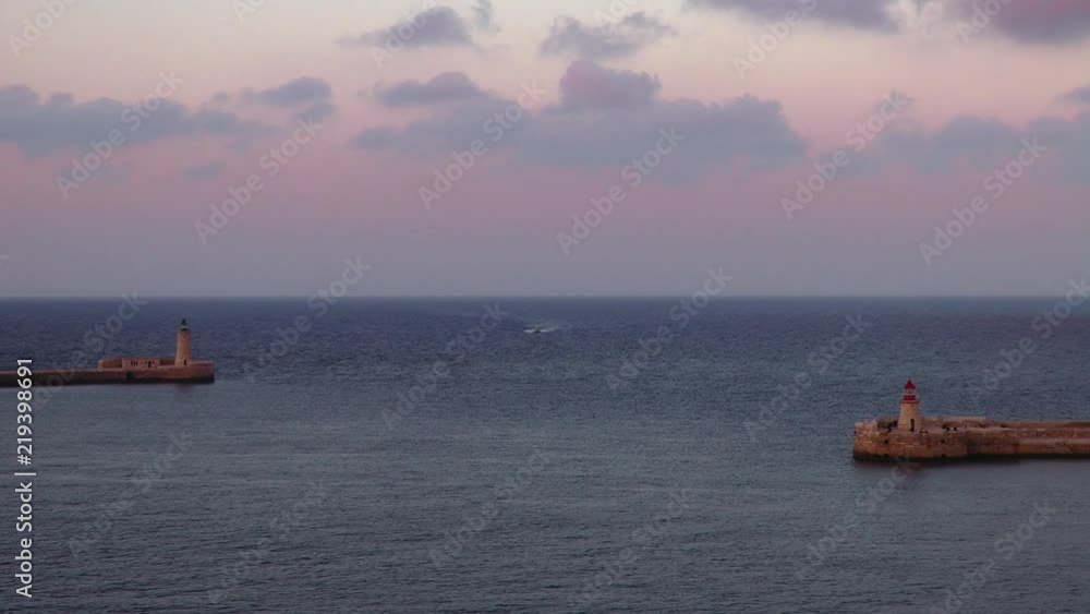 The view of the entrance to the Grand Harbor at sunset time on Malta The view of the entrance to the Grand Harbor at sunset time on Malta