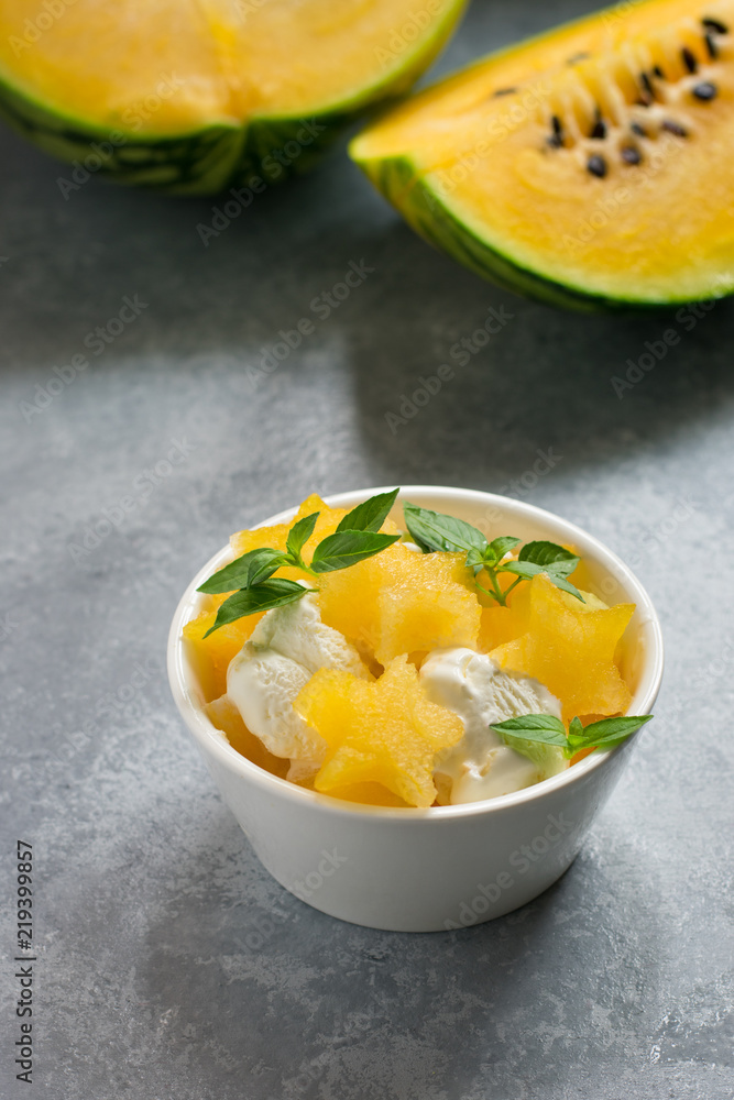 Yellow watermelon slices and ice cream, decorated with green leaves. Yellow watermelon slices and ice cream, decorated with green leaves.