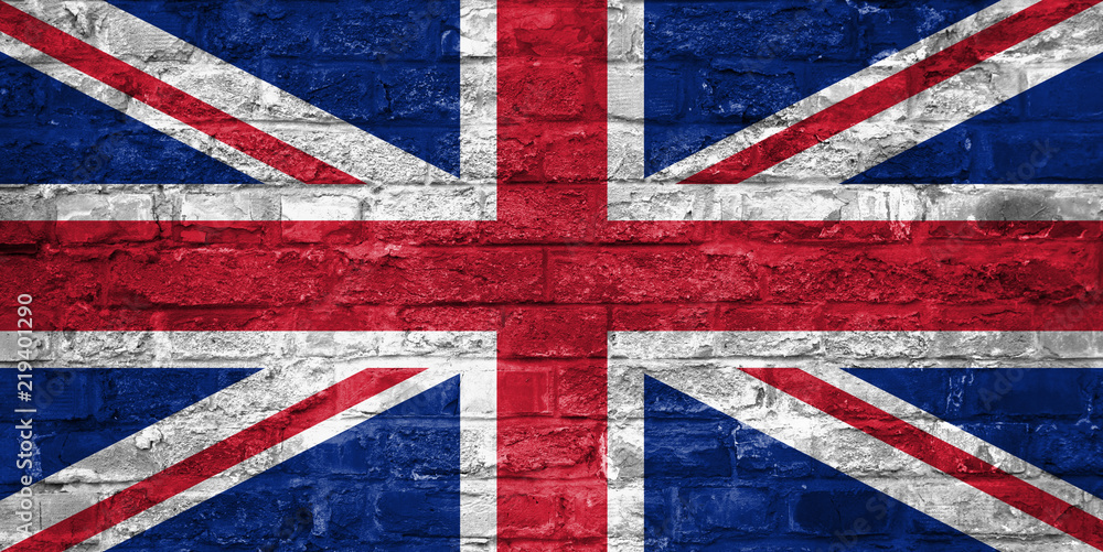 Fototapeta premium Flag of United Kingdom over an old brick wall background, surface