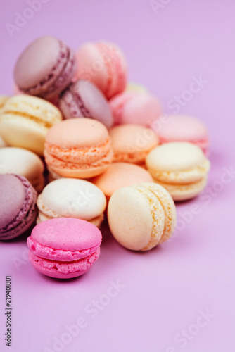 Sweet french macarons on pink background.