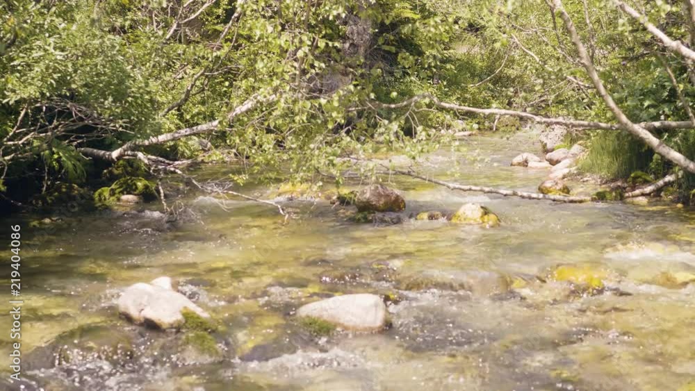 Water flow in rocky river. Flowing water in mountain river Water flow in rocky river. Flowing water in mountain river