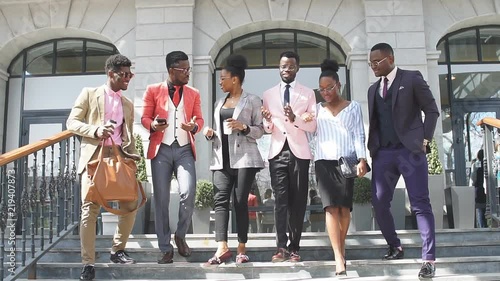 young cheerful people are going home after working day. the end of working day