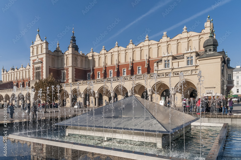 Naklejka premium The fountain near the beautiful Cloth Hall in the historic center of Krakow, Poland