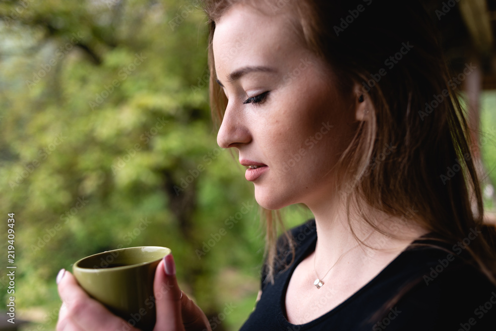Portrait of a young girl drinking tea Portrait of a young girl drinking tea