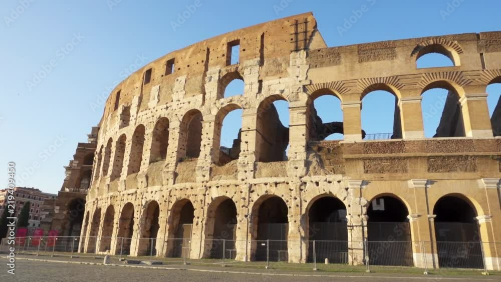 Famous Italian attraction Colosseum in Rome. Veiw on ancient Flavius amphitheater Coliseum in capital of Italy. Camera moving from left to right Famous Italian attraction Colosseum in Rome. Veiw on ancient Flavius amphitheater Coliseum in capital of Italy. Camera moving from left to right